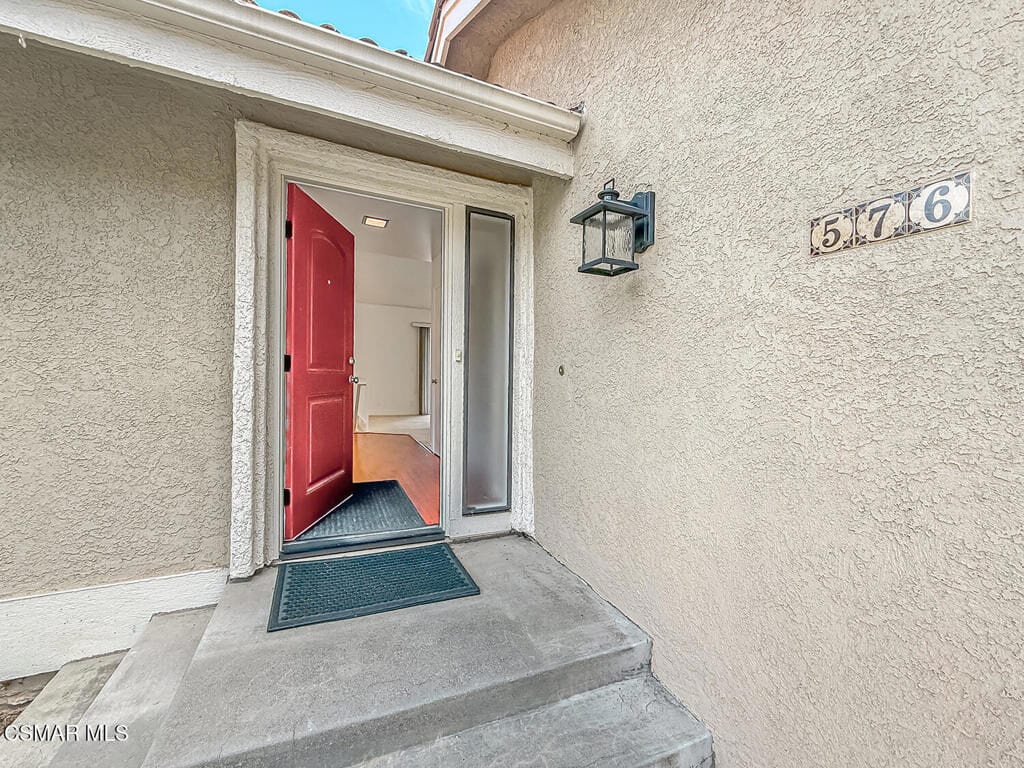 A red front door standing open, from one of Connie's listings