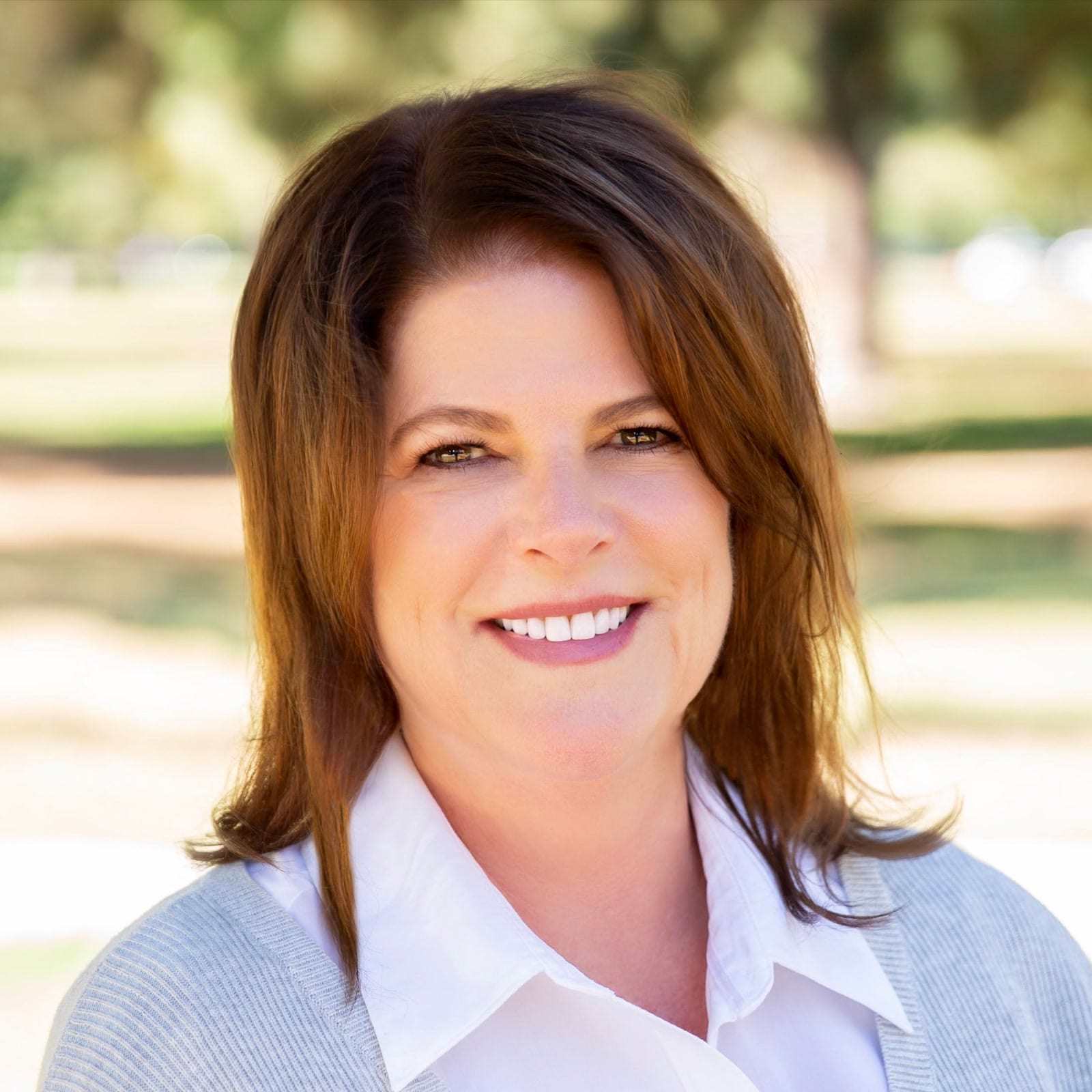 Connie Poe smiling outdoors in a park