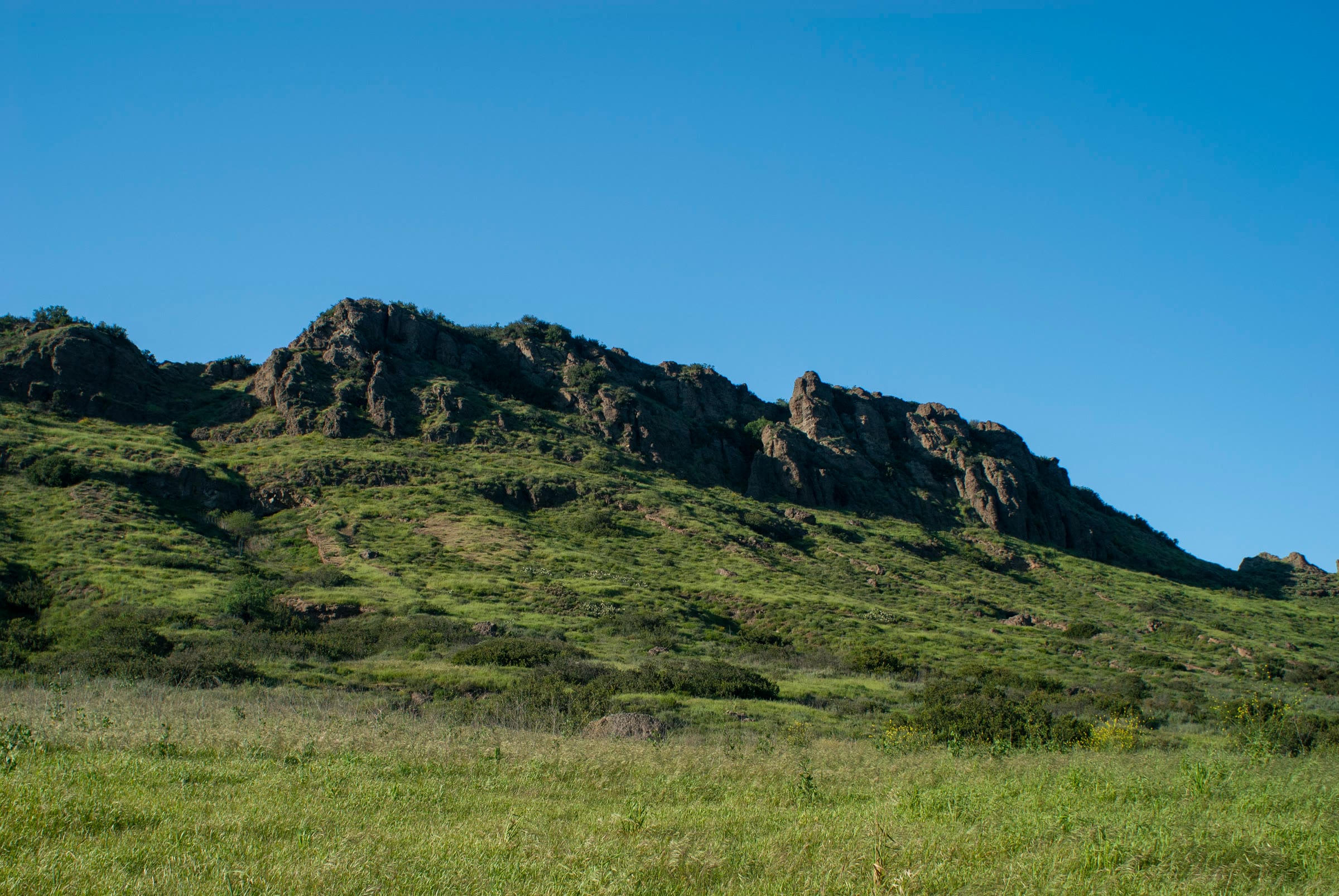 A rocky ridgeline above green meadows in Wildwood Regional Park, Thousand Oaks